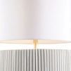 Close-up of Porticello lamp base showing detailed irregular vertical fluting texture under white shade