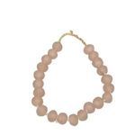 Blush pink sea glass beads arranged in a loose loop showing string detail