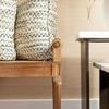 Close-up side view showing tapered leg, leg carving, and armrest of Paris Bench with pillows