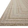 Close-up angled side view showing the rug’s textured weave and fringed edge