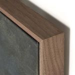 Close-up of walnut floater frame corner with visible wood grain and canvas edge