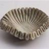 Brown marble bowl with natural veining and a unique ruffled edge design