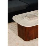Living room setup with Dash coffee table on patterned rug in front of black cushioned sofa