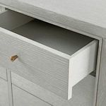 Open drawer revealing light gray wood interior of Paola cerused oak dresser with smooth finish