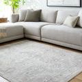 Square version of the rug styled in living room under sectional sofa with throw pillows and modern art