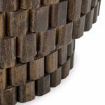 Extreme close-up of the natural wood grain and carved block detailing on the table base
