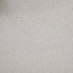 Close-up of upholstery fabric speckled with tiny colored fibers, highlighting denim texture