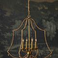 Nimes Chandelier hanging against dark scenic wallpaper with lights turned on