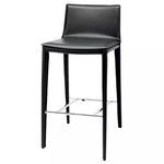 Three-quarter view showing sleek upholstery and chrome footrest of Palma Bar Stool