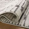 Folded edge of rug displaying plush texture and tightly finished binding in charcoal and dove colors