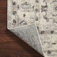 Rug corner lifted to reveal woven backing and clean edge finishing