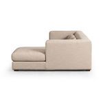 Side profile showing the sectional’s wide armrest and thick cushions on the right chaise