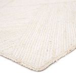 Close-up low angle of rug corner highlighting fiber texture and subtle natural color variations