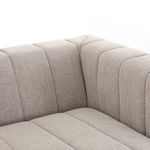 Angled view of sectional’s corner illustrating smooth fabric and deep channel sewing