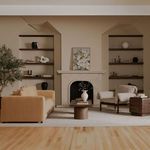 Camel color Davie Sofa staged in a living room with fireplace, modern wood coffee table, and armchairs.