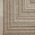 Corner of Dawn Organic rug showing close-up of woven pattern and fringe on neutral flooring