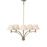 Linus Chandelier illuminated, showing warm glow through the cream fabric shades