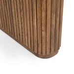 Detailed close-up of rounded base of fluted wood leg showing grain and finish