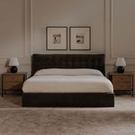 Tuve table lamps on nightstands flanking a dark upholstered bed with framed art in neutral bedroom