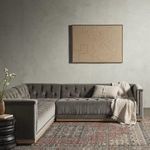 Living room setup with sectional, small side table, and cozy chair