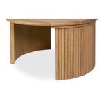 Curved fluted oak leg with natural finish viewed from side of round table