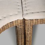 View under the bench showing open rattan base structure with legs and support framing
