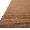 Close-up angled view showing thick ribbed texture and dense wool fibers of terracotta rug