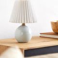 Ferez lamp on natural wood surface with books and wooden bowl, angled slightly to side