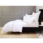 Side view of Sheena Bamboo Sateen duvet set showing bed legs, folded duvet edge, and gray paneled wall background.