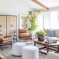 Wynter rug in styled room with brown leather chairs, white poufs, wooden coffee table, and light walls