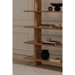 Casey bookcase in styled room setting with decorative bowls, books, and warm ambient lighting