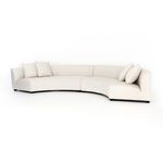 Close-up showing two square cushions with detailed piped edges on cream sectional upholstery