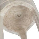 Underside view revealing circular cut patterns and natural knots in wood