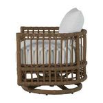 Side view highlighting the open weave pattern of the brown rattan arms and frame