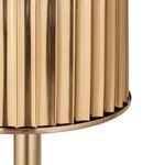 Close-up on vertical ridged texture and metallic shine of gold steel ice bucket exterior