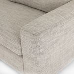 Close-up detail of tight weave grey upholstery fabric on wide armrest