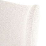 Close-up on the top edge of the chair backrest showing rounded contour and fabric detail