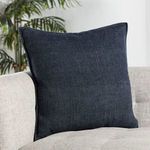 Blanche pillow styled on beige couch with plants in background showing room context