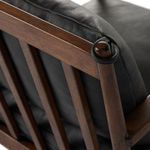 Back angle showing cushion tied with leather strap on wood post with slat design