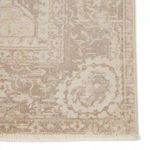 Close-up of intricate corner pattern with delicate vintage-style border and muted woven colors