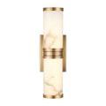 Brenham Brass Wall Sconce shown from front with soft glow through alabaster shade