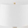 Top view focusing on the white linen drum shade and brass finial
