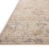 Close-up of Milena Ivory / Granite rug corner showing woven edges and muted color pattern