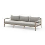 Three-quarter angle showing sofa depth and rounded back cushions from the front