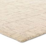 Close-up angled view showing dense wool pile highlighting cut and loop texture in neutral tones