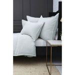 Close up side profile of pillows and duvet showing the flange edging and textured fabric