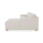 Side profile of Farrow Sectional showing curved arm and high back cushions in textured oat fabric