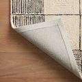 Francis rug corner lifted to show wool underside and finished edge stitching on wood floor