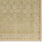 Close crop of corner pattern with focus on the muted green and blue medallion tiles