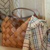 Close-up of the throw casually hung on side of basket near fireplace showing texture and fringe